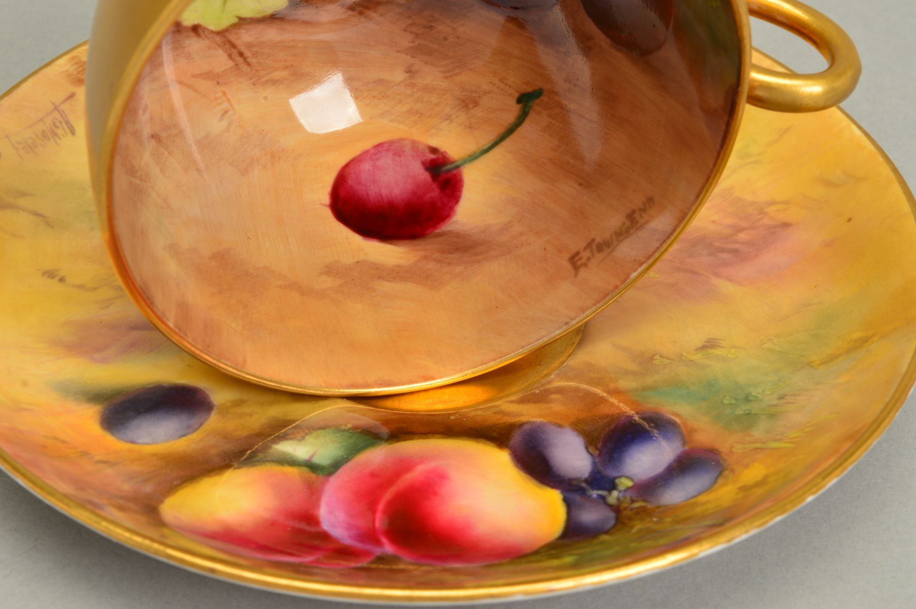 A ROYAL WORCESTER FRUIT STUDY TEACUP AND SAUCER, the exterior of the cup gilded, the interior - Image 3 of 5