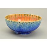 A RUSKIN POTTERY EGGSHELL BOWL, having a blue mottled glaze to the exterior and an orange and blue