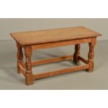 ROBERT THOMPSON OF KILBURN MOUSEMAN OAK RECTANGULAR COFFEE TABLE, the adzed top on four octagonal