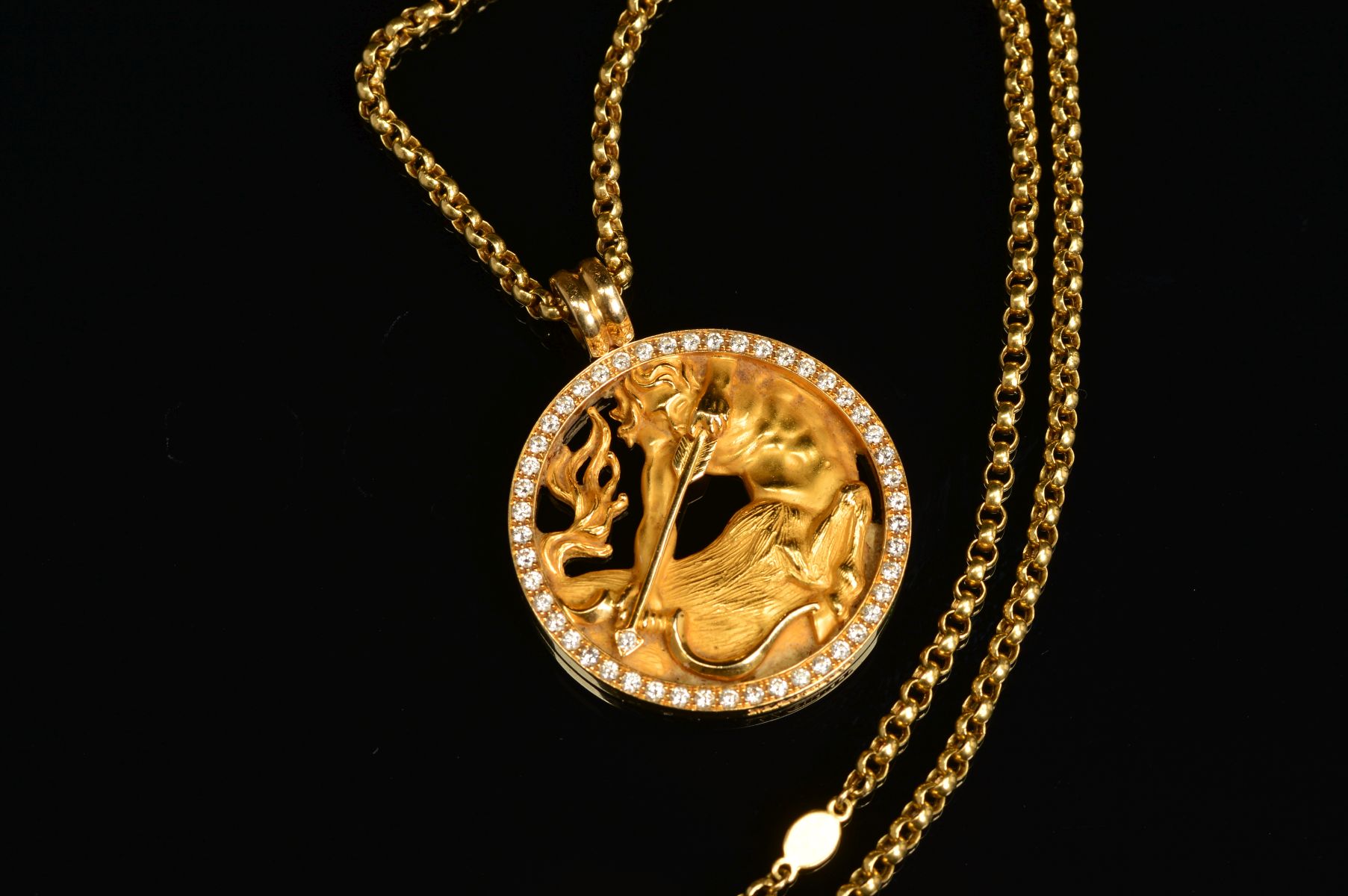 A MAGERIT DIAMOND SET SAGITTARIUS PENDANT AND CHAIN, the circular pendant depicting a centaur with