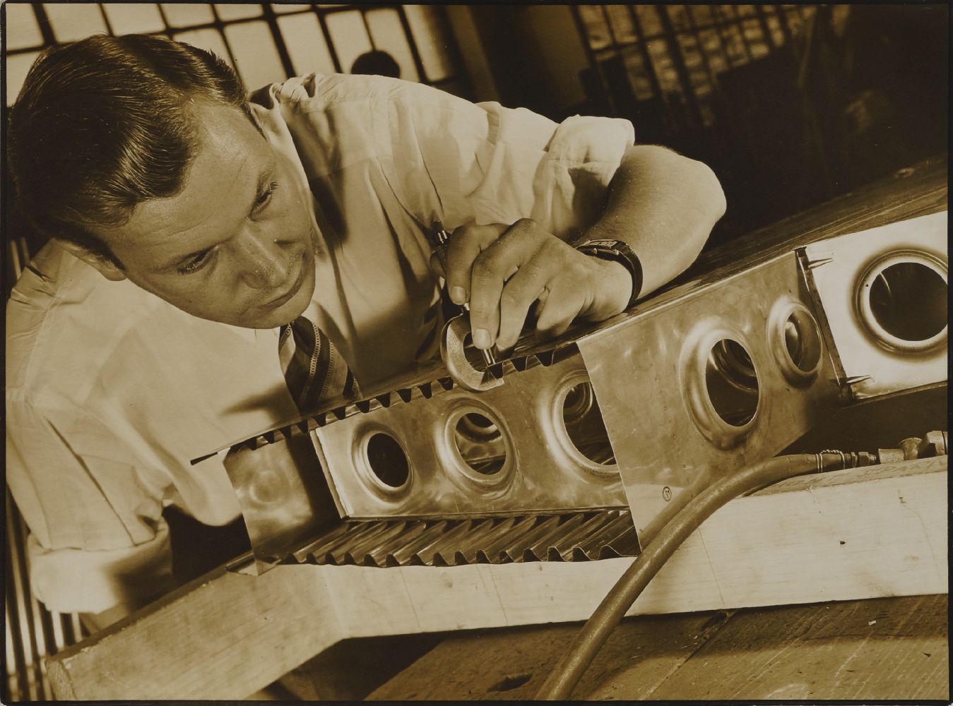 Margaret Bourke-White, American 1904-1971- Man doing metalwork; gelatin silver print, inscribed in