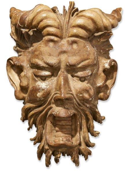 A large Italian carved wood mask of Pan, 18/19th century, with short curving horns, down cast eyes