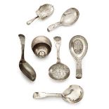 A George III silver jockey cap form caddy spoon, Birmingham c.1799, maker IT, together with six