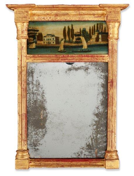 A gilt wood pier mirror, 19th century, with fluted column uprights, the frieze inset with a