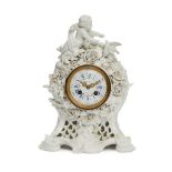 A Continental white porcelain clock, late 19th century, the top applied with a cherub and dove on