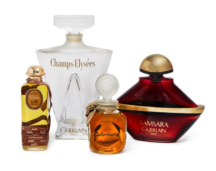 A large Guerlain 'Champs-Elysees' shop display perfume bottle, 39cm high, together with three
