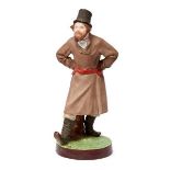 A Russian porcelain figure of a gentleman wearing a hat, Gardner factory, late 19th century, with
