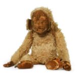 A Merry Thought plush monkey, with a printed expression on his face, with velour hands and feet,