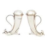 A pair of silver peppers, Birmingham c.1908, Henry Matthews, of cornucopia form, with dolphin