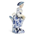 A Meissen blue and white porcelain figure of a lady playing a Hurdy-gurdy from the Gallant Orchestra