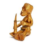 An African tribal metal alloy figure of a seated man with a mortar, Ivory Coast, early/mid 20th