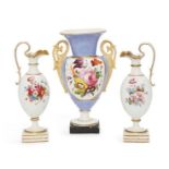 A pair of English porcelain urns, 19th century, with flaring gilded spouts and scrolling handles, to