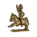 A brass toy figure of a soldier, India, 19th century, on a rectangular base, the rider and horse