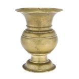A brass vase, India, 18th century, of baluster form, on a domed foot, with wide flaring rim, 24.2cm.