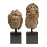 Two Gandharan red sandstone heads, reworked in areas, 3-4th century AD, depicted wearing