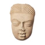 A large sandstone face of Buddha, India, Gupta period, with peaceful expression, the thin eyebrows