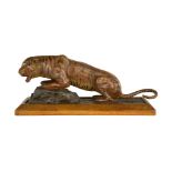 A painted plaster model of a tiger, India, early 20th century, on a rectangular oak base, shown