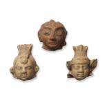 Three small stone heads, India, Gupta period, moulded with wide elongated eyes, two with elaborate