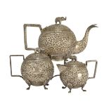 An Indian three piece silver tea service, Kutch, late 19th century, of globular form, the lids