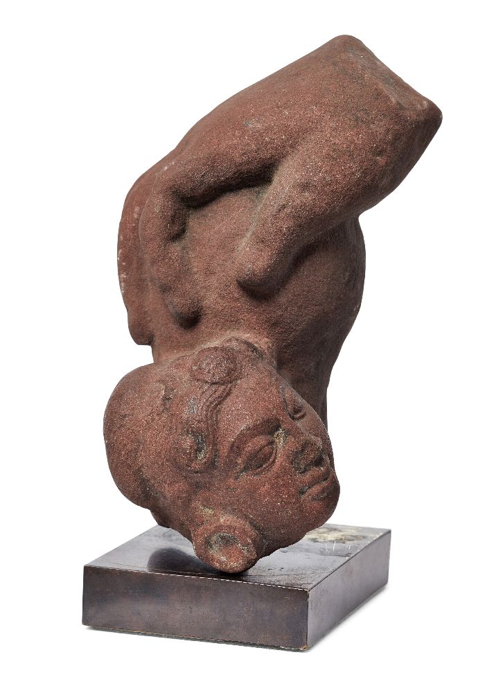 A red sandstone fragment of a hand and female head, Madhya Pradesh, India, 10th century, the large