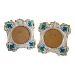 Hutton & Sons, a pair of Art Nouveau silver, oak and enamel photograph frames Mark of Hutton &