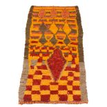 Moroccan, a handwoven long pile wool rug Second quarter 20th century Woven in red and orange with