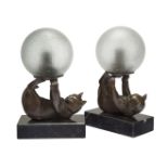 Janle, a pair of Art Deco cold-painted metal table lamps 'Juggling cats', c.1930, each signed '