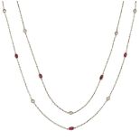 A platinum, diamond and ruby long chain necklace, the spectacle-set circular-cut diamonds to oval