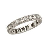 A diamond eternity ring, composed of a single row of circular-cut diamonds in a pave setting, ring