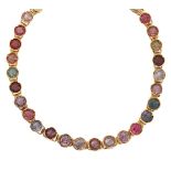 A multi-gem bracelet, composed of a series of circular-cut coloured gemstones including garnet,