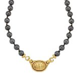 A haematite necklace with panel clasp, by Lalaounis, with central oval medallion depicting an