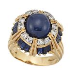 An 18ct gold, sapphire and diamond ring, by Kutchinsky, the domed cluster set in the centre with a