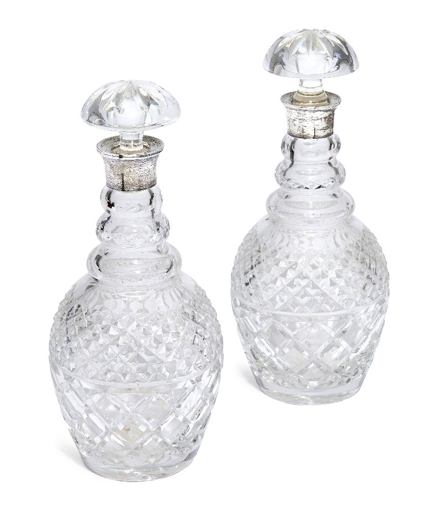 A pair of cut glass decanters with silver collars, London c.1985, Garrard & Co Ltd., with associated