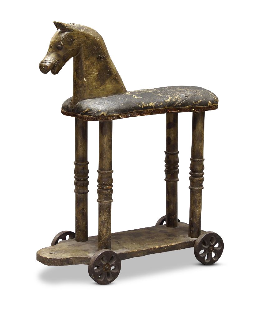 A child's hobby horse, late 19th century, with a leather covered seat, on four reel turned