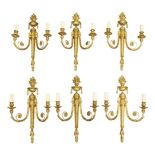 A set of six Louis XVI style gilt bronze twin-light wall appliques, 20th century, the backplates