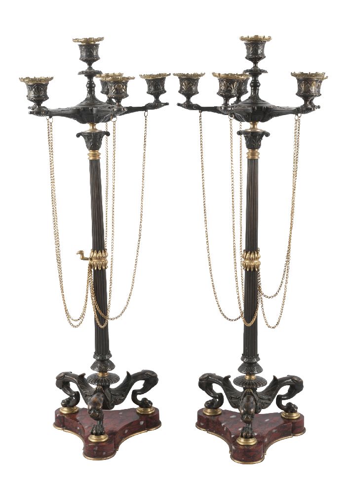A pair of French gilt and patinated bronze six-light candelabra, in the manner of Barbedienne, c.