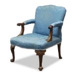 A George II armchair, the serpentine shaped backrest, above acanthus carved and scrolling