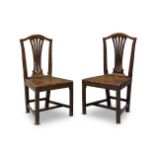 A pair of George III mahogany dining chairs, the serpentine top rails above pierced waisted splats