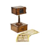 A Victorian walnut stereoscopic viewer, late19th century, the square viewing box with shaped eye-