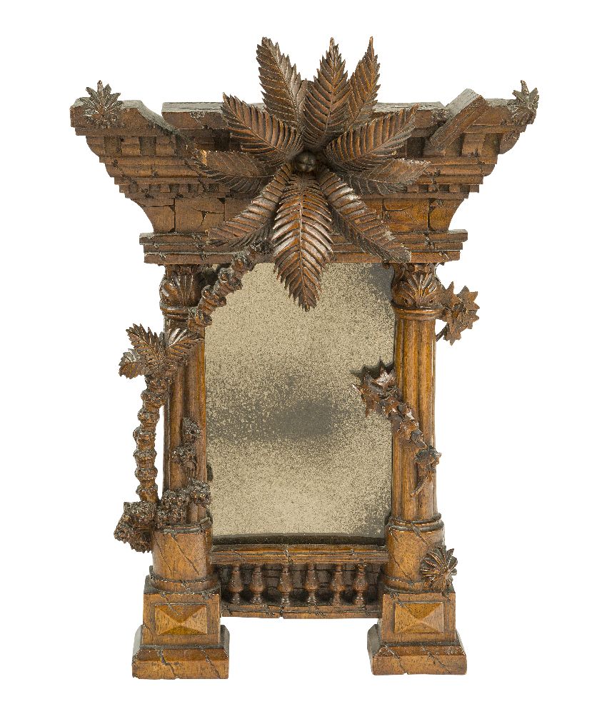 An Italian carved walnut mirror modelled as a classical ruin, 19th century, the rectangular plate
