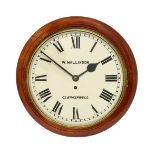 A walnut circular wall clock by W. Wallison, with a white paint dial and Roman numeral chapter ring,