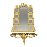A giltwood and gesso triple plate mirror, 19th century, of arched form, the pierced crest centred by