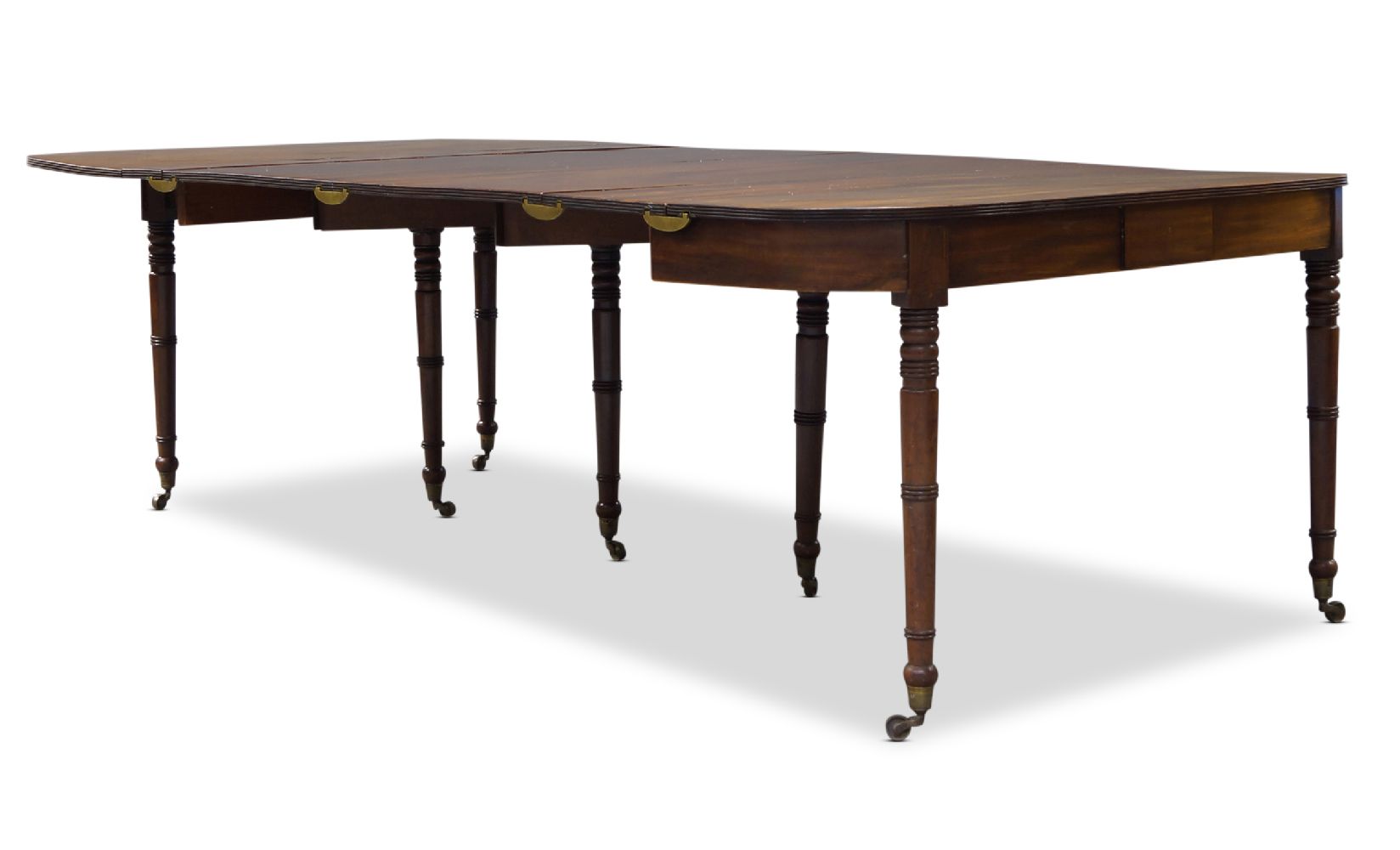 A George IV mahogany folding and extending dining table, with rounded rectangular top, having four