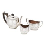 A silver three piece tea set, Birmingham c.1914, Joseph Gloster Ltd., of ovoid form, engraved with