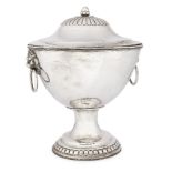 A white metal punch bowl on stand and cover, probably Indian, with lion mask and ring handles,