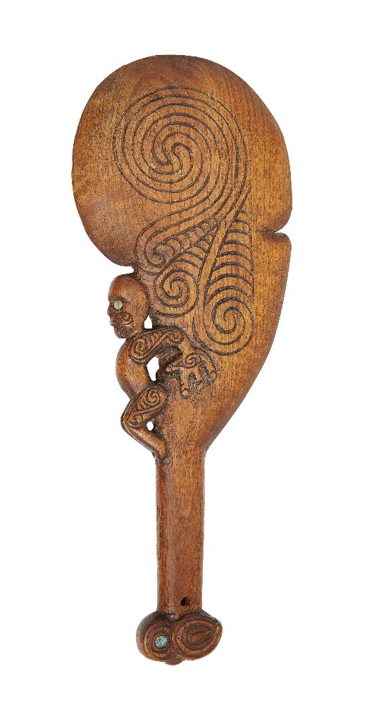 A Maori wood hand club, early 20th century, with a tiki figure projecting from the side decorated