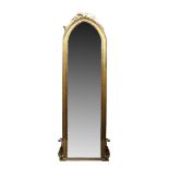 A large gilt wood and gesso pier mirror, 19th century, of arched form, the mirror plate with stiff