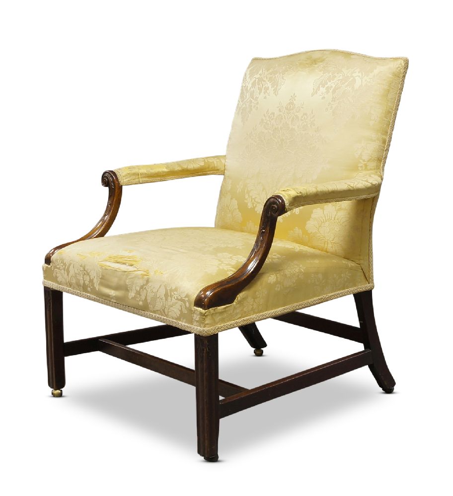 A George III Gainsborough armchair, the serpentine backrest, above downward swept arms with carved