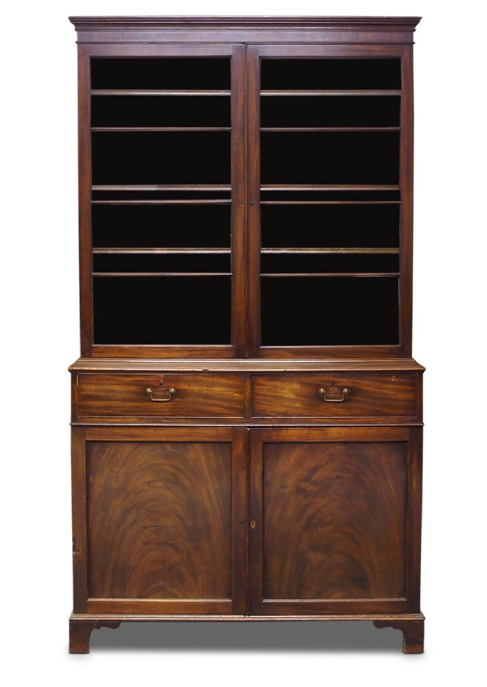 A George III mahogany bookcase, the moulded cornice above two glazed doors, enclosing three shelves,