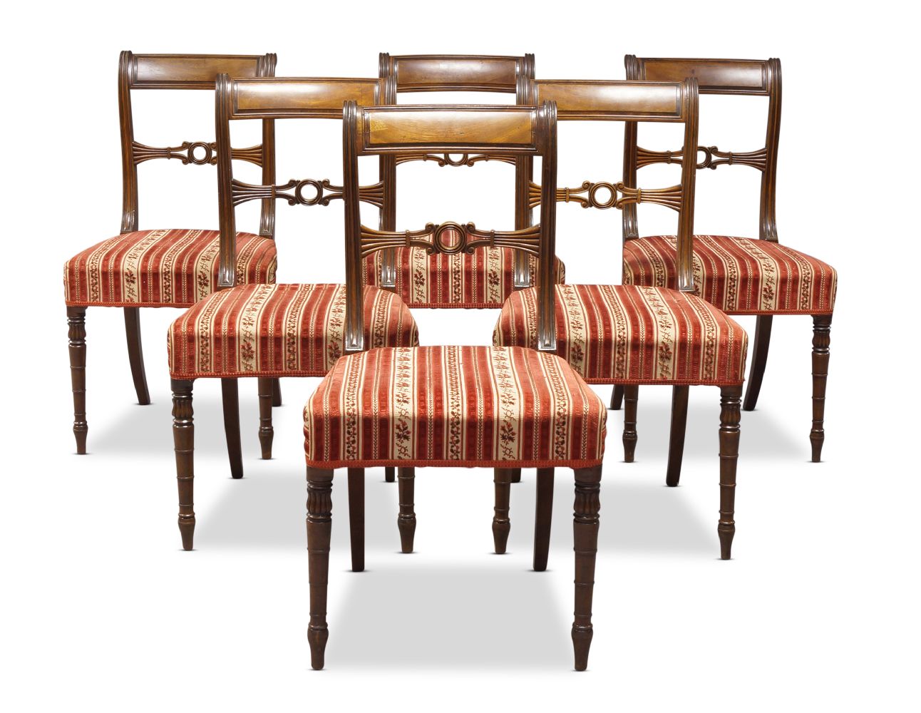 A set of six Regency mahogany bar back dining chairs, the curved backrests, with carved and